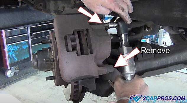 remove brake caliper mounting bolts