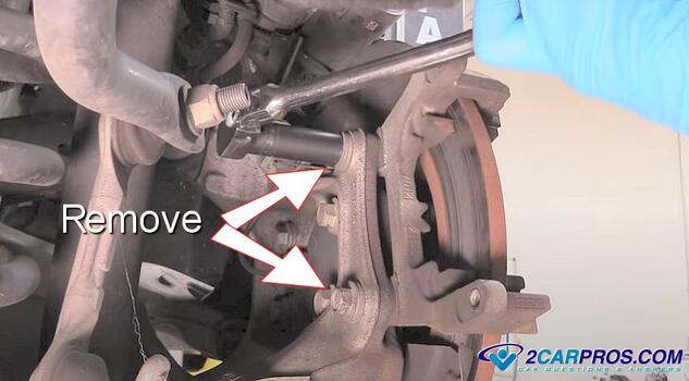 remove brake caliper mounting bracket bolts
