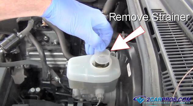 remove brake master cylinder fluid strainer