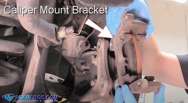 remove brake caliper mounting bracket