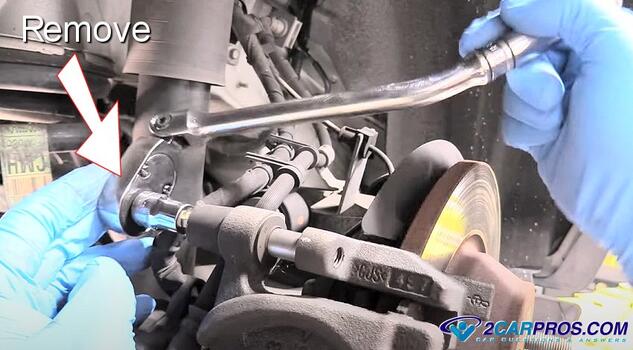 remove rear brake caliper mounting bolts